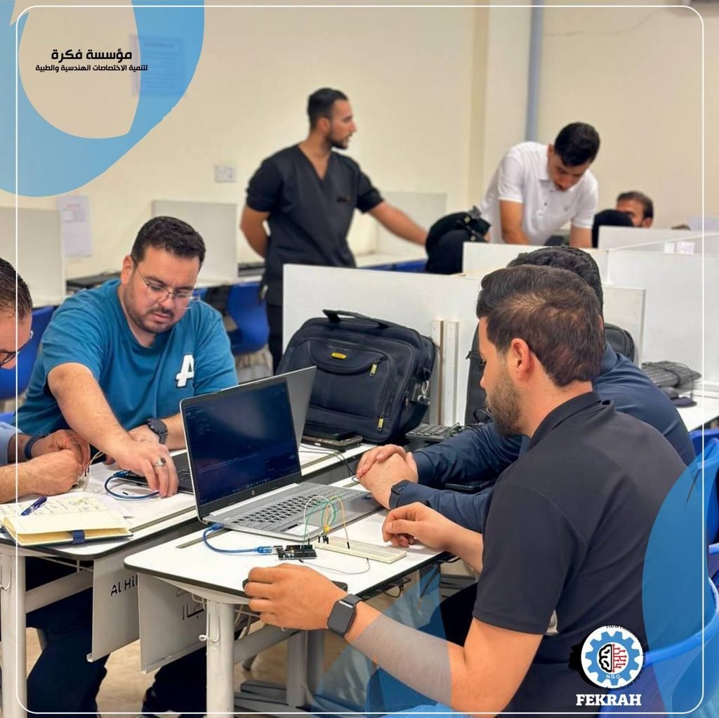 Fekrah Foundation training activity with participants working on technical and educational projects.